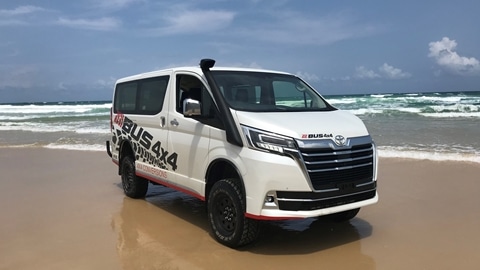 Finished van parked on the beach next to the ocean | image for the 4WD Touring Australia page.
