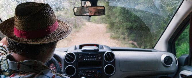 Basics of Off Roading: How to Get Started 22 Man in a wicker hat driving down a dirt road | image for the Basics of Off Roading: How to Get Started blog.